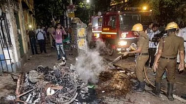 Firefighters dousing flames in Kolkata after BJP supporters allegedly clashed with Trinamool supporters during Amit Shah’s road show on Tuesday/Twitter