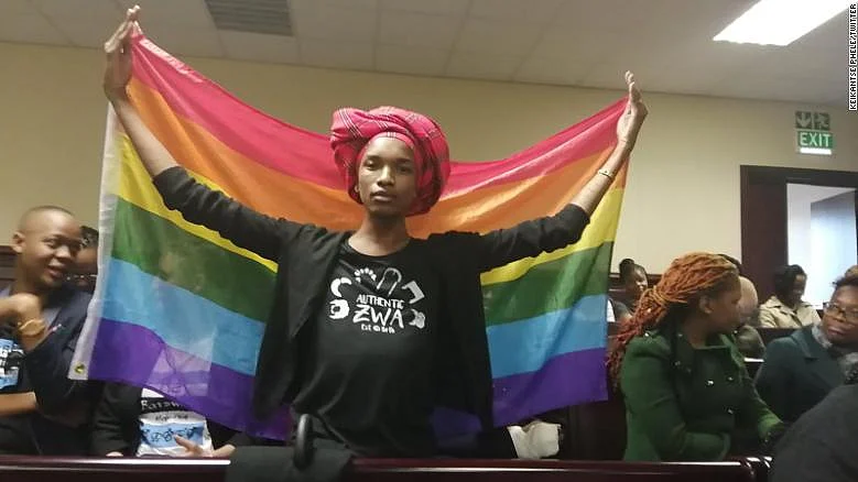 Activist Kat Kai Kol-Kes holds a LGBTQ pride flag inside Botswana’s High Court (Social Media)