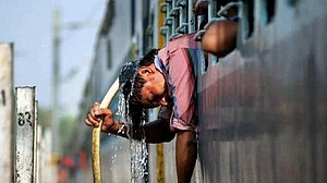 A railway worker douses himself with water from a pipeline (representative image: PTI)
