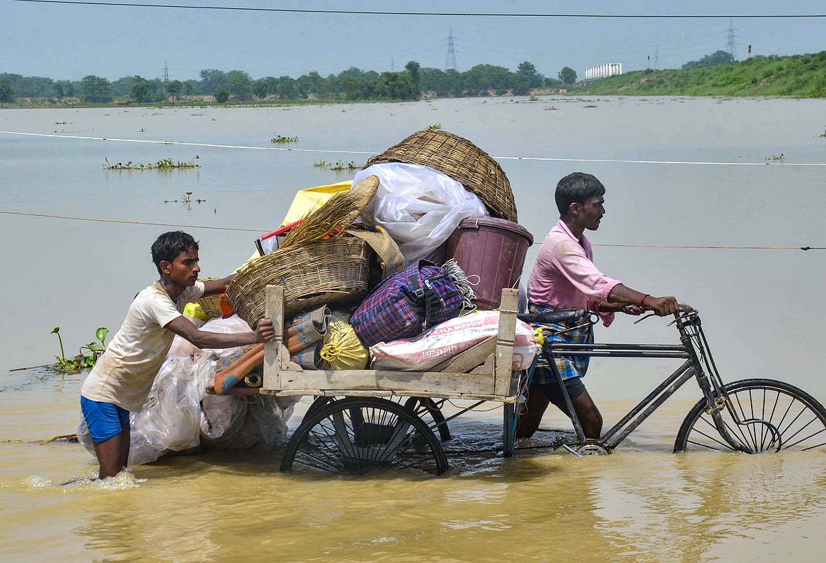 Flood-affected villagers transport their belongings to a safer place from their flooded village at Mithan Sharay in Muzaffarpur district, Bihar