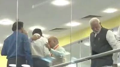 PM Modi after Sivan broke the news of losing link with Moon lander. Sivan (in white shirt) is seen being comforted by his colleagues.&nbsp;