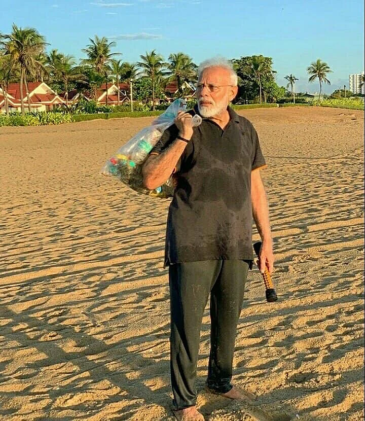 PM Narendra Modi with a bagful of garbage he picked up on the beach .