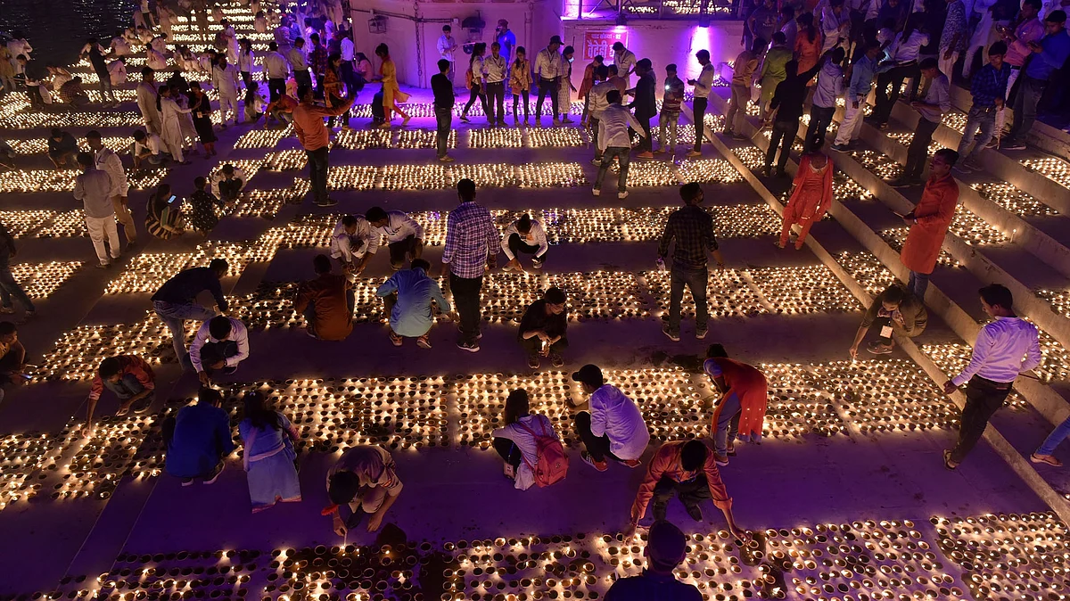 People light oil lamps during ‘Deepotsav’ in Ayodhya on October 26, 2019. (Photo: IANS)