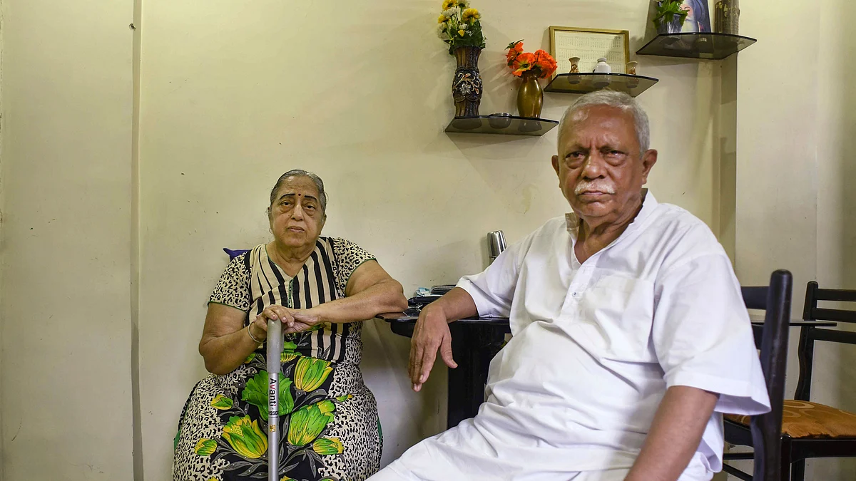 Senior citizen Harish Malkani (69) with his wife Rani Malkani (L) at their home in Mumbai. Both husband and wife are retired civil servants and have deposited all their savings in PMC Bank.(PTI Photo)