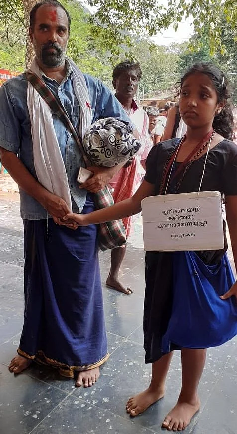 Hridya Krishna (9) with her father as she bids adieu to Lord Ayyappa. Entry of women of menstruating age is prohibited in the shrine.