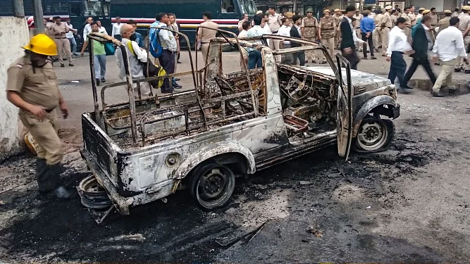 A police vehicle allegedly set on fire by the rampaging lawyers at Tis Hazari district court in Delhi on Nov 2. (PTI photo)