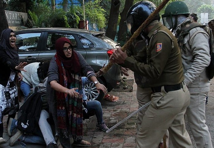 The two girls standing up to policemen who are brutally raining batons at one and all during anti-CAA protest on Sunday.