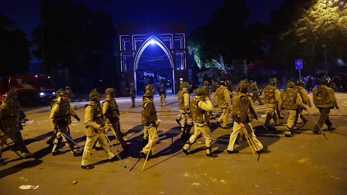 Policemen stand guard near Jamia Millia Islamia following the protests against Citizenship Amendment Act, in New Delhi, Sunday, Dec. 15, 2019 (PTI Photo)