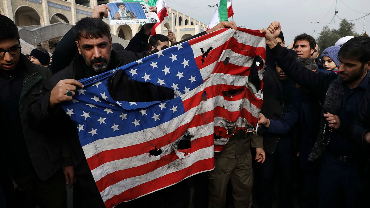 Protesters burn a U.S. flag during a demonstration over the U.S. airstrike in Iraq that killed Iranian Revolutionary Guard Gen. Qassem Soleimani, in Tehran (PTI)