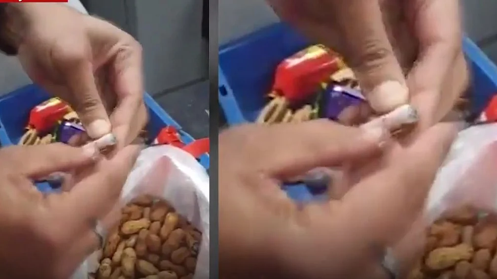 Screengrab of the video showing foreign currency notes hidden in peanuts