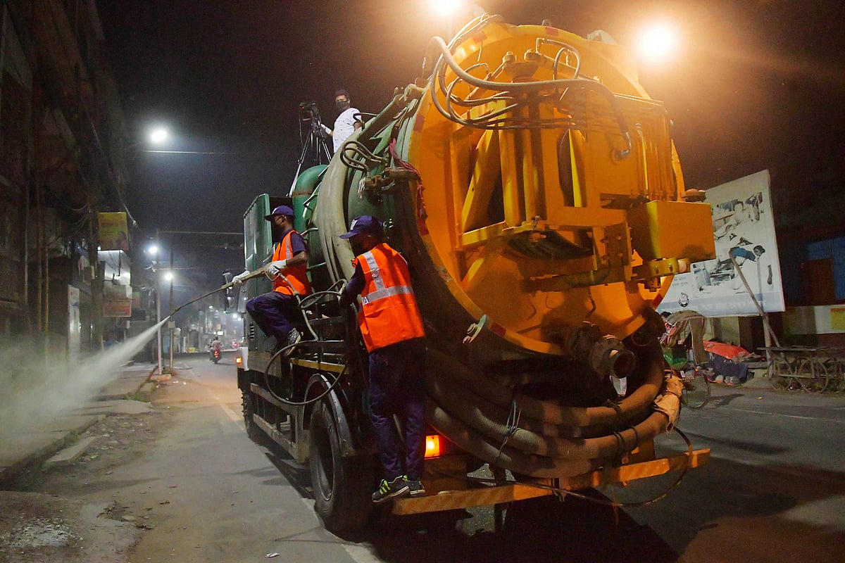 Municipal workers spray disinfectant in different parts of Agartala city , to contain the coronavirus, in Agartala. capital of the Northeastern state of Tripura, India