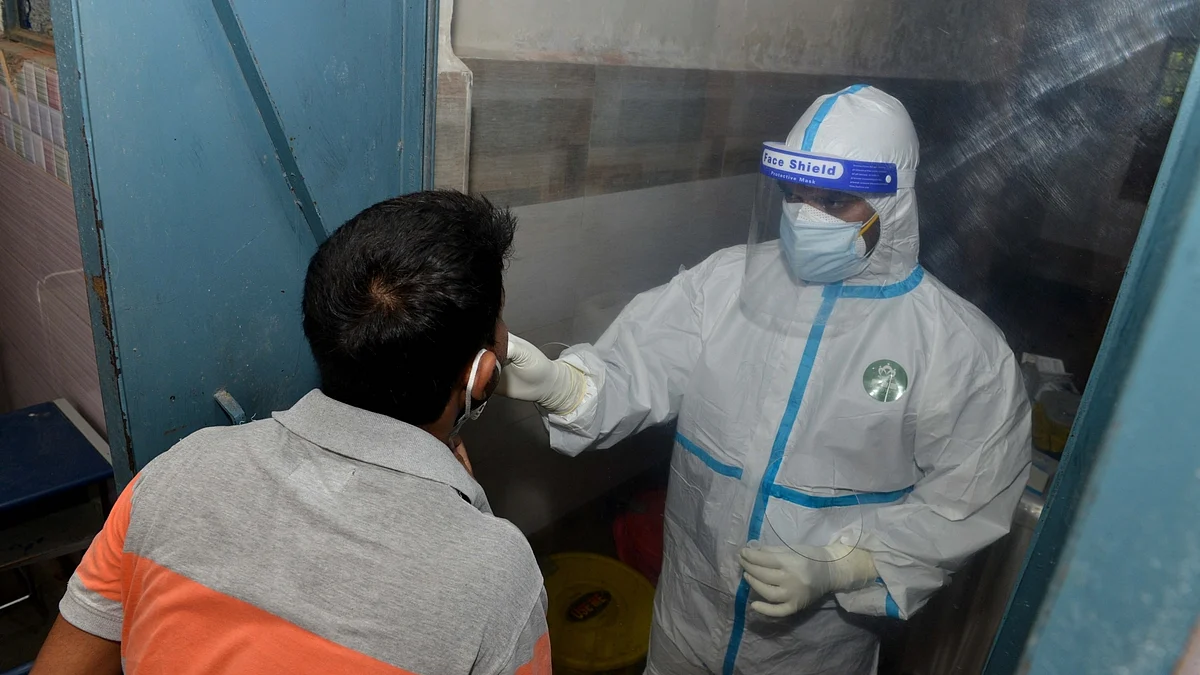 A health worker collects swab samples for rapid antigen testing for COVID-19, in New Delhi on June 23, 2020