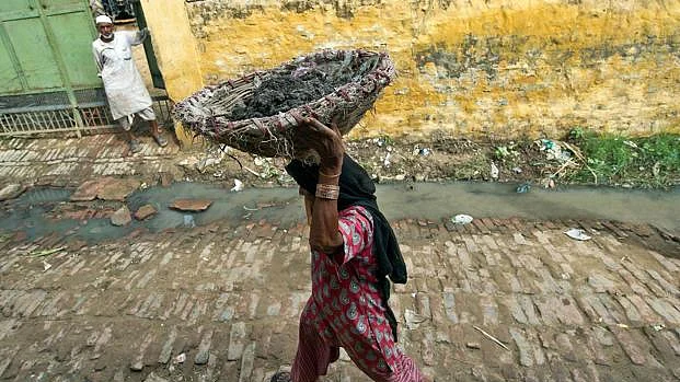 A Dalit woman carrying human waste on her head. (Representative image)