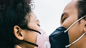 Is it safe to mask kiss in a partially vaccinated world?