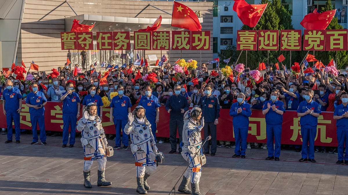 Chinese astronauts from China's Manned Space Agency, right to left, Tang Hongbo, Nie Haisheng, and Liu Boming salute at a departure ceremony before launch of the Senzhou-12
