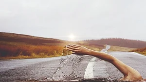 2 UP men swim long distance with hands, feet tied