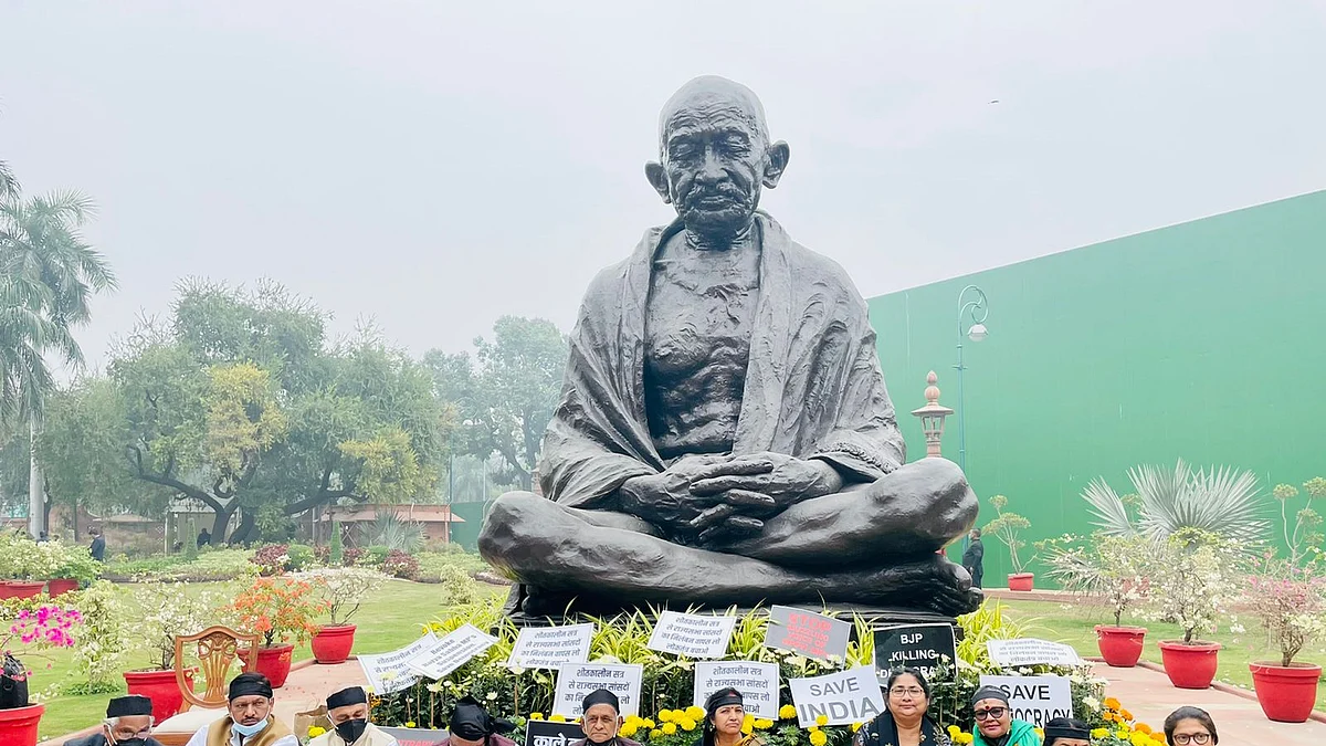Opposition MPs protest in front of Gandhi Statue inside Parliament House campus against the suspension from Rajya Sabha