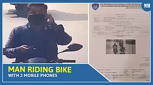 Vadodara Police issues e-challan to the man who was riding bike with 2 mobile phones