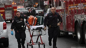 US subway shooting: Police continue to hunt for 'person of interest'