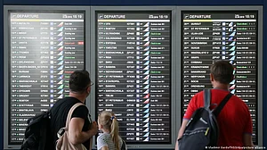 Representative image of passengers checking flight schedules.