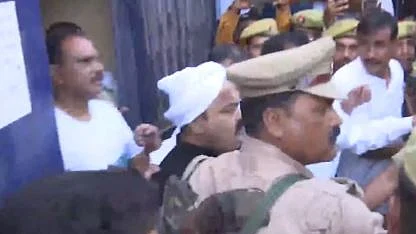 Atiq Ahmed (centre) being taken to a UP police van outside Sabarmati jail on Sunday