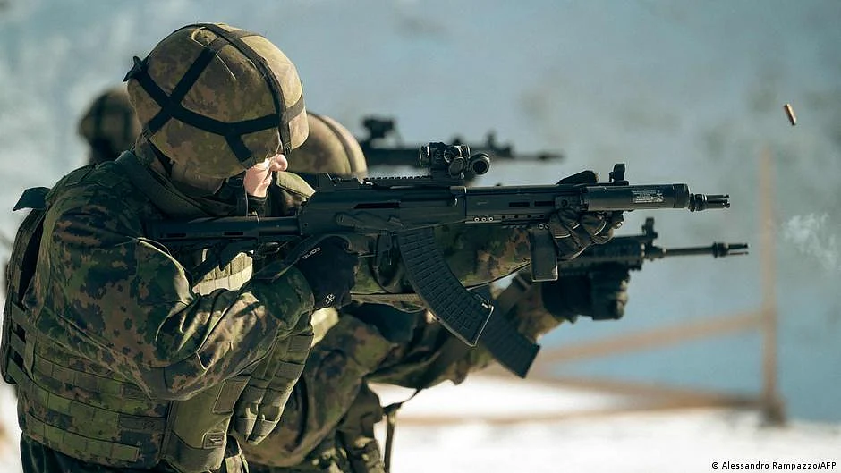 A soldier holding an automatic rifle