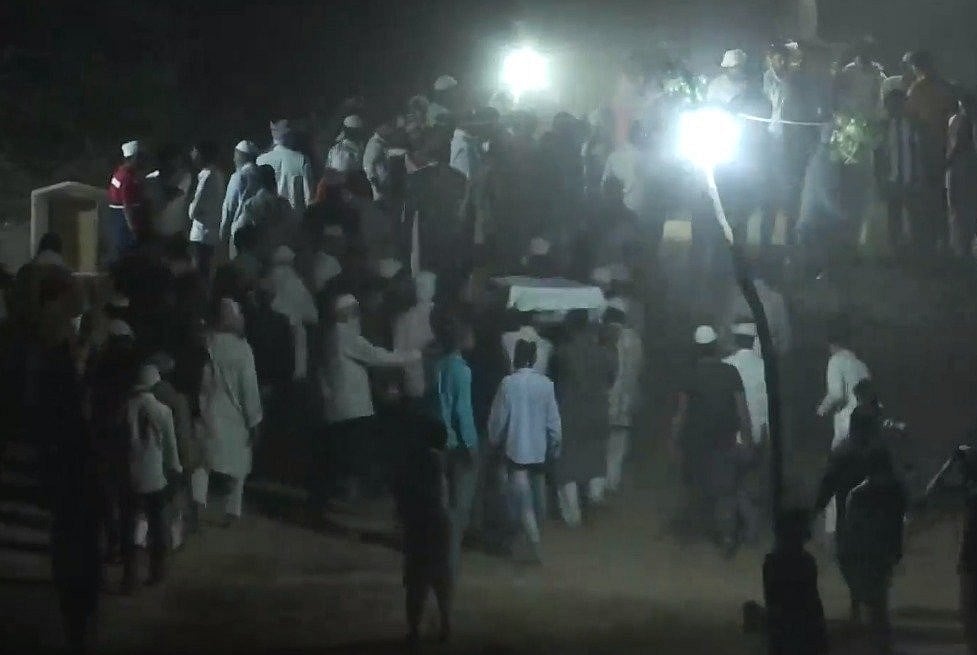 Bodies being buried in Kasari Masari graveyard