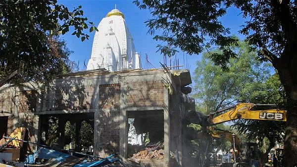 Indore: The demolition of illegal construction at the Beleshwar Jhulelal Mahadev Temple is underway where 36 people were killed after stepwell collapse, in Indore, Monday, April 3, 2023. (PTI Photo)