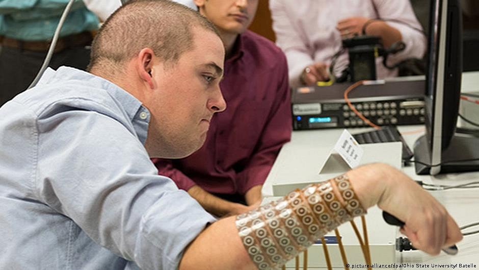 Brain implant helps paralyzed man use hand