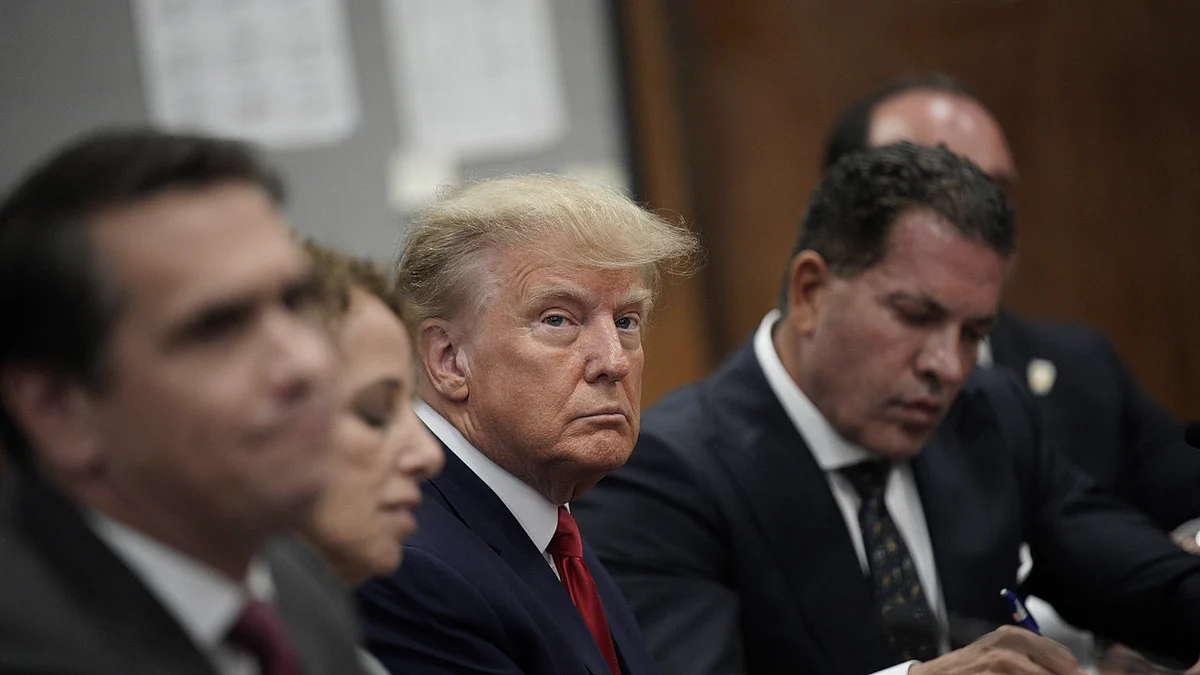 Former U.S. President Donald Trump with his defence team in a Manhattan court during his arraignment on April 4.