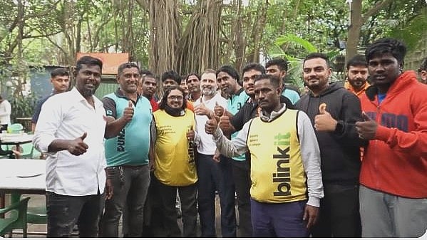 Rahul Gandhi with gig workers in Bengaluru on Sunday. Image: @IYC/ Twitter 