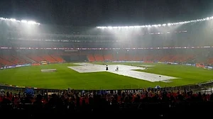 Spectators at the Motera stadium in Ahmedabad wait for the rain to stop (Photo: IANS)