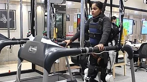 A patients walks on a treadmill with the help of wearable robotic limbs. Photo: IANS