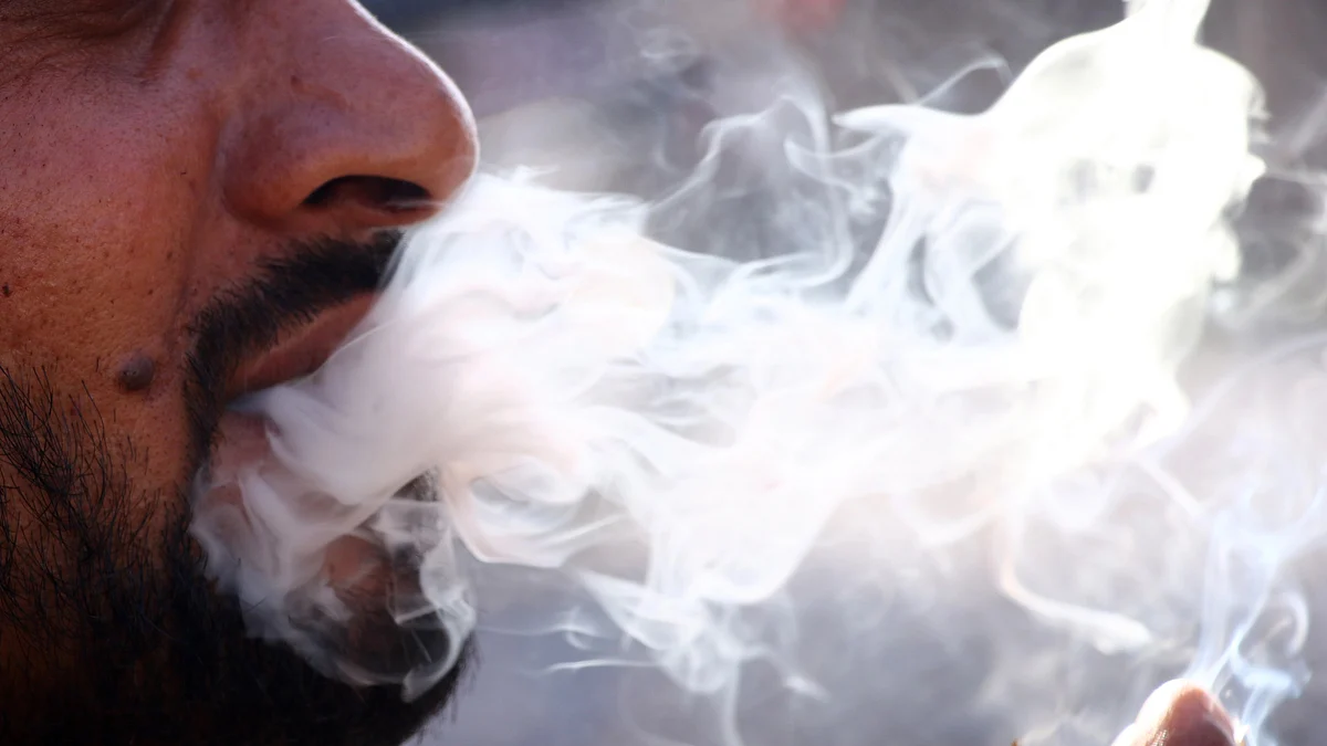 A person smokes a cigarette  (photo: Getty Images)