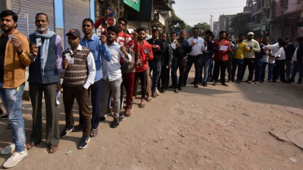 Voters seen standing in queues to cast their vote inside a Polling booth (Photo: Getty Images)