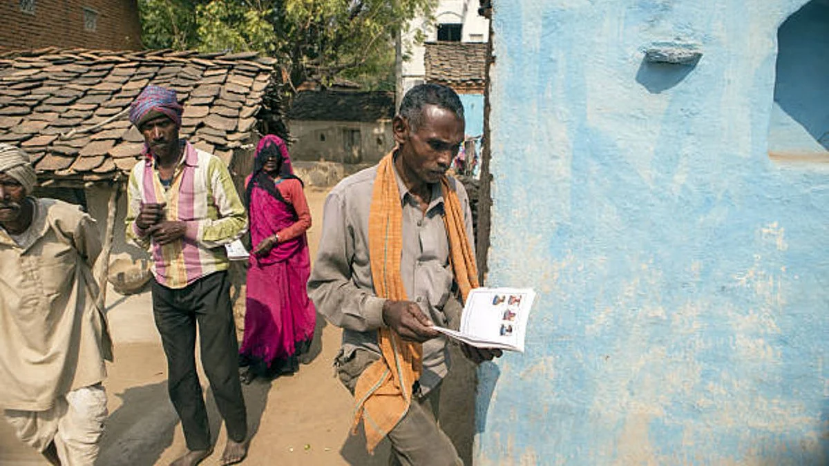 A villager holds an empty job card to be filled in accordance to MNREGA (Getty Images)