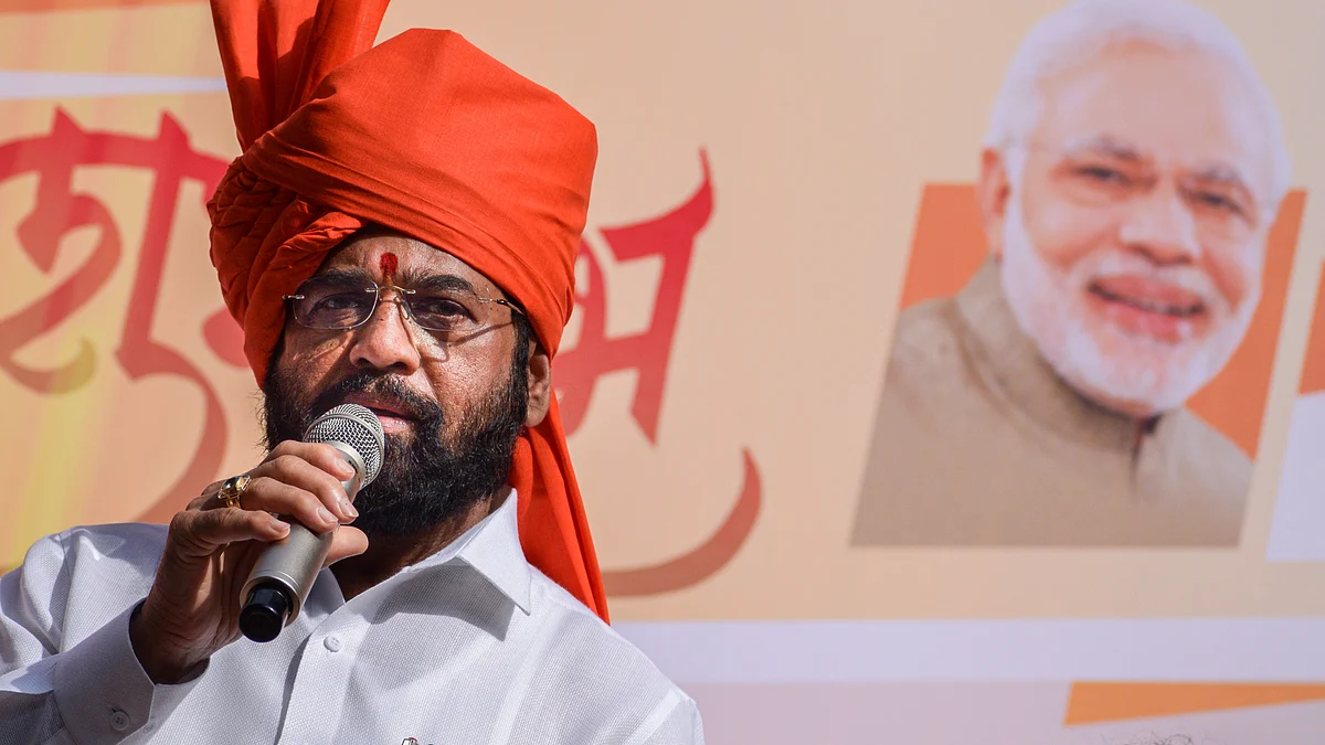 Maharashtra chief minister Eknath Shinde in saffron turban during a Maharashtra Day procession, with a banner featuring Prime Minister Narendra Modi in the background
(photo: Sankhadeep Banerjee/NurPhoto via Getty Images)