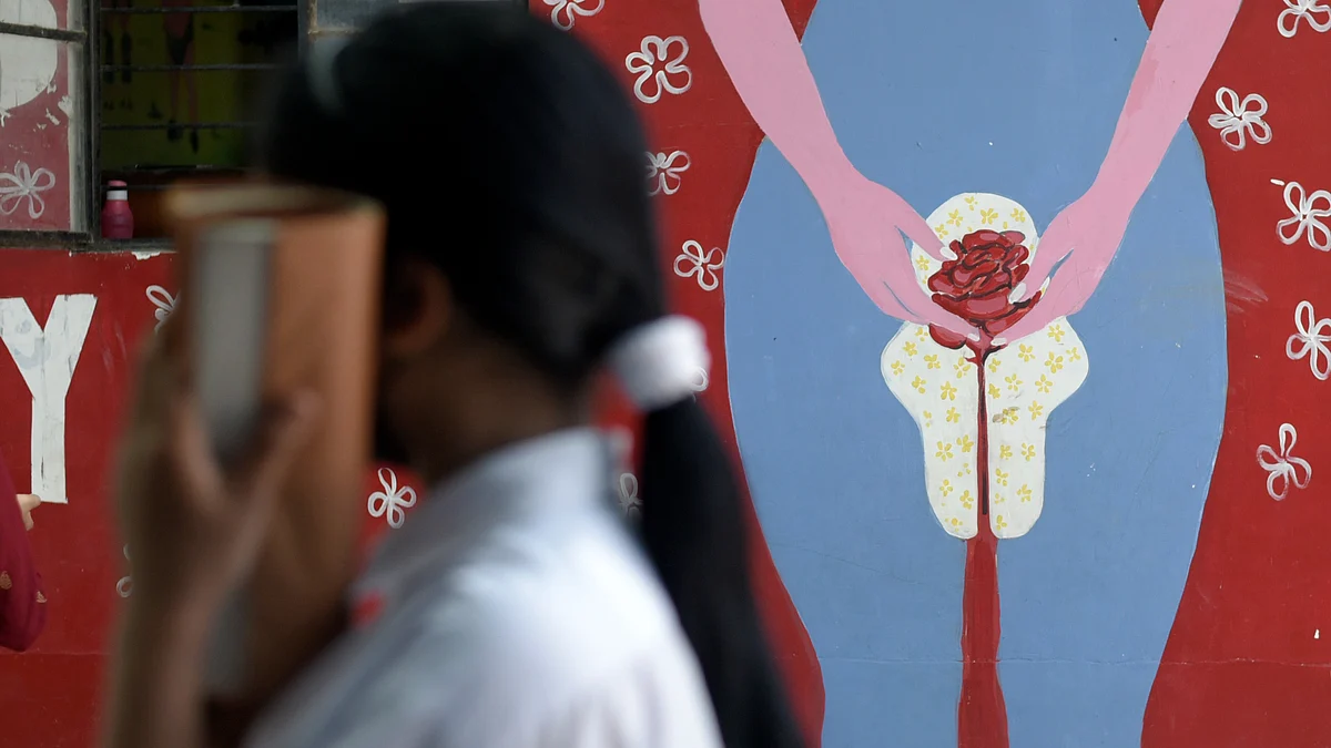 Representative image of a young girl with a pack of sanitary napkins (Photo: National Herald archives)