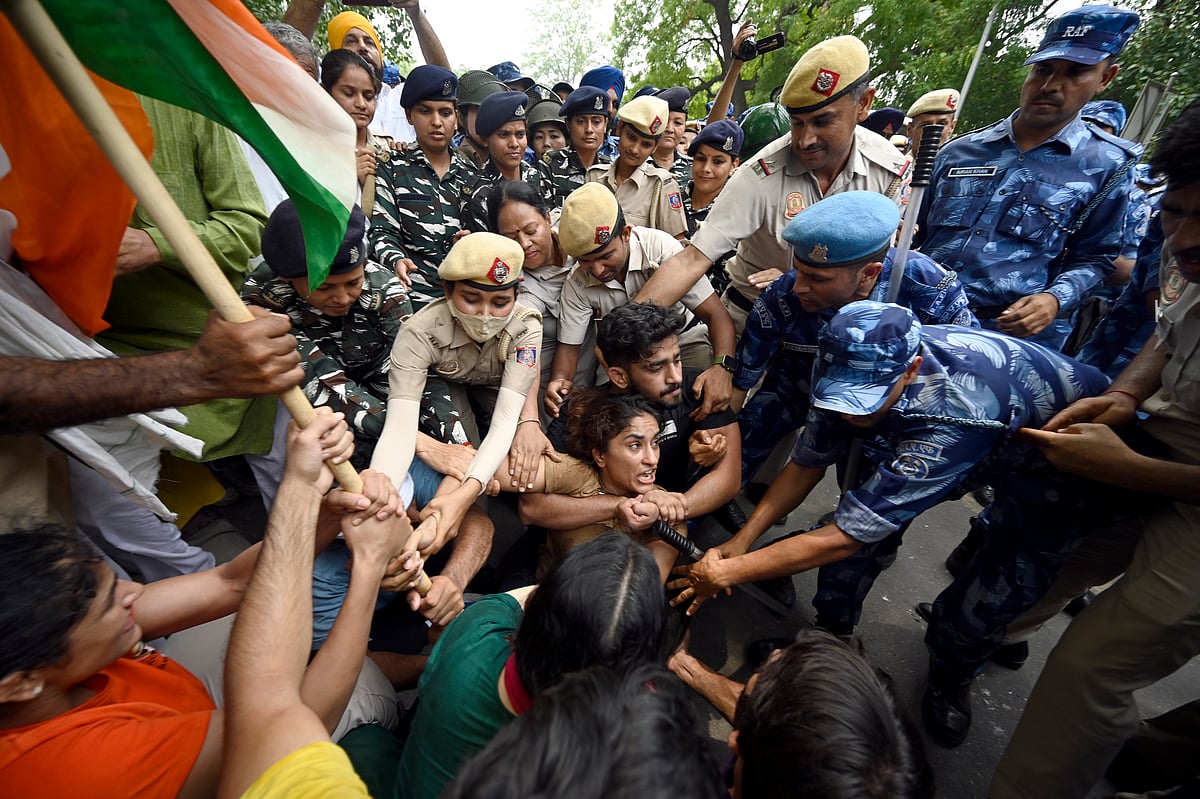 Security personnel put down wrestler Vinesh Phogat and others during their march toward the new Parliament building, on Sunday, May 28, 2023 in New Delhi, India. (Photo: Getty Images)