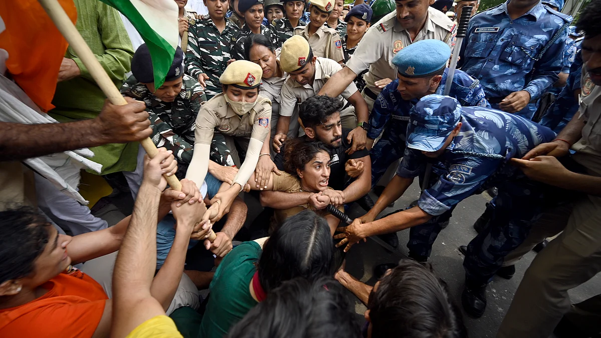 Security personnel put down wrestler Vinesh Phogat and others during their march toward the new Parliament building, on Sunday, May 28, 2023 in New Delhi, India. (Photo: Getty Images)