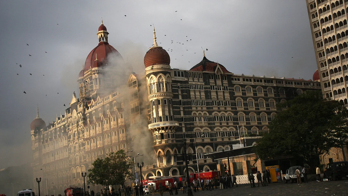 Firefighters attend to a fire as it burns at Taj Mahal Palace & Tower Hotel following an armed siege on November 29, 2008, in Mumbai, India (Photo by Uriel Sinai/Getty Images)