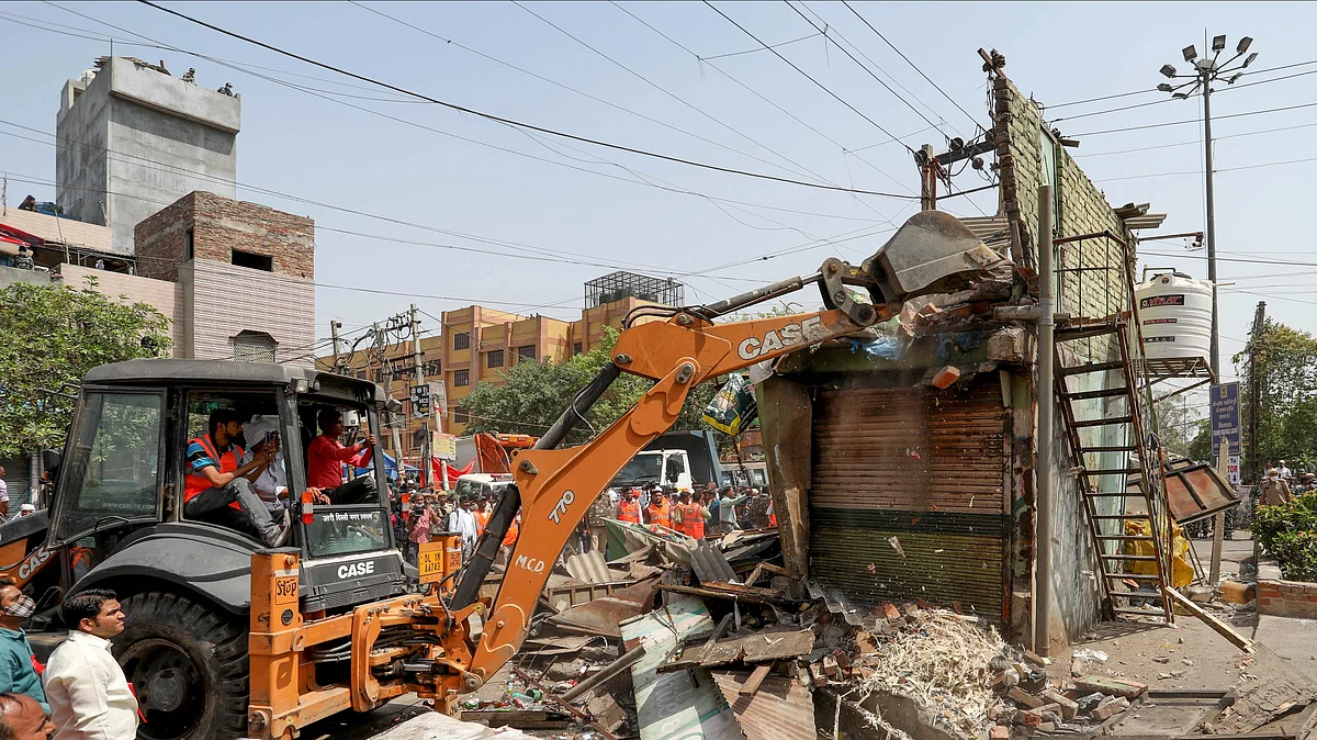 A bulldozer demolishes a structure during a joint anti-encroachment drive conducted by North Delhi Municipal Corporation (MCD) at Jahangirpuri area (Photo: Getty Images)