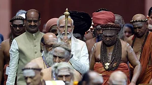 The prime minister carried a sengol he had already paid obeisance to into the Lok Sabha flanked by ranks of Hindu high priests (Photo PIB)