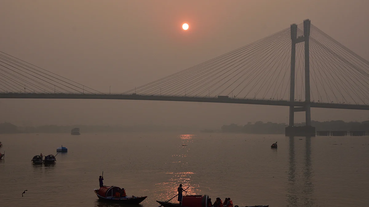 People travel in their boats during the last sunset across the   Howrah Bridge (Photo: Getty Images)