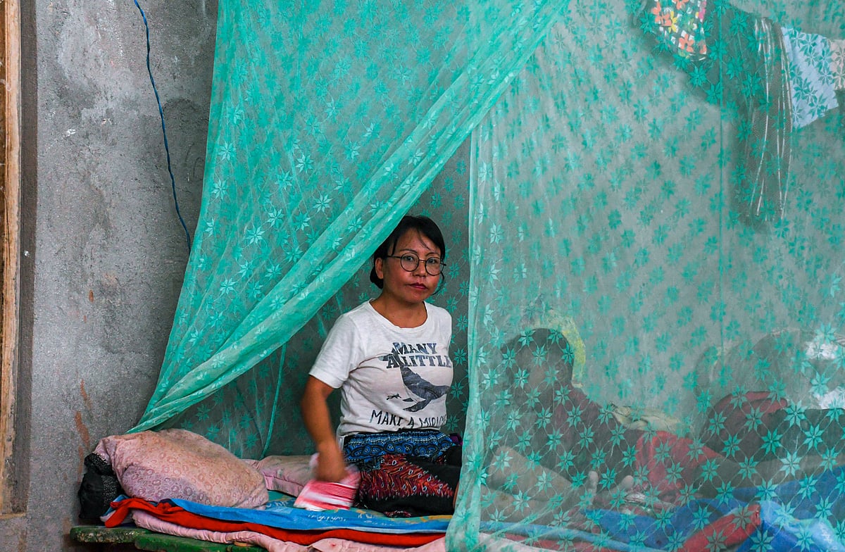 Churachandpur, Manipur: A woman reacts to the camera as she sits in a makeshift relief camp at Saidan village (photo: Getty Images)