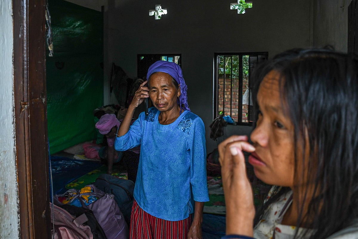 Churachandpur, Manipur: An elderly woman talks on her cell phone at a makeshift relief camp in Saidan village (photo: Getty Images)