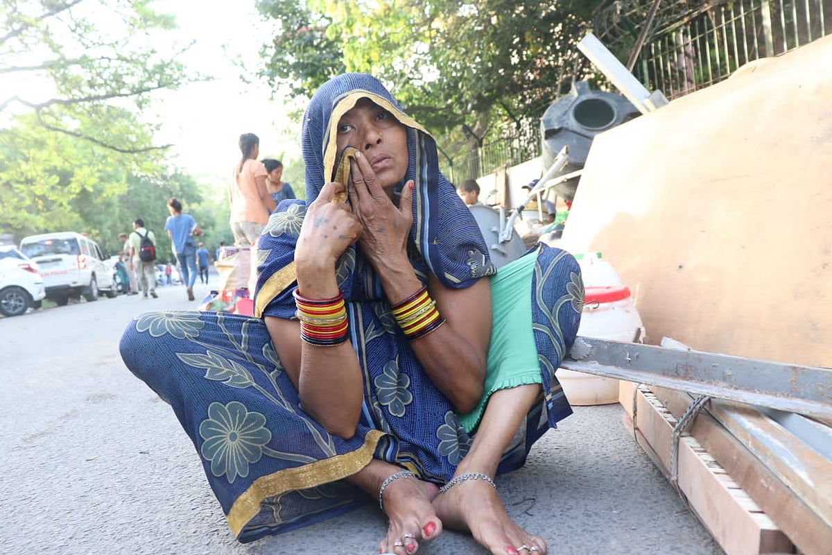 Resident sitting outside the compound (Photo courtesy: AICCTU)