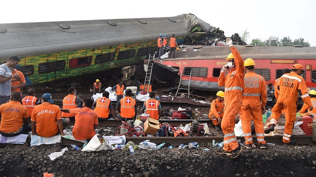 NDRF teams, working in shifts, take a break at the site of the triple train accident in Odisha's Balasore. Several emergency personnel said it was the worst they had ever seen (photo: Getty Images)