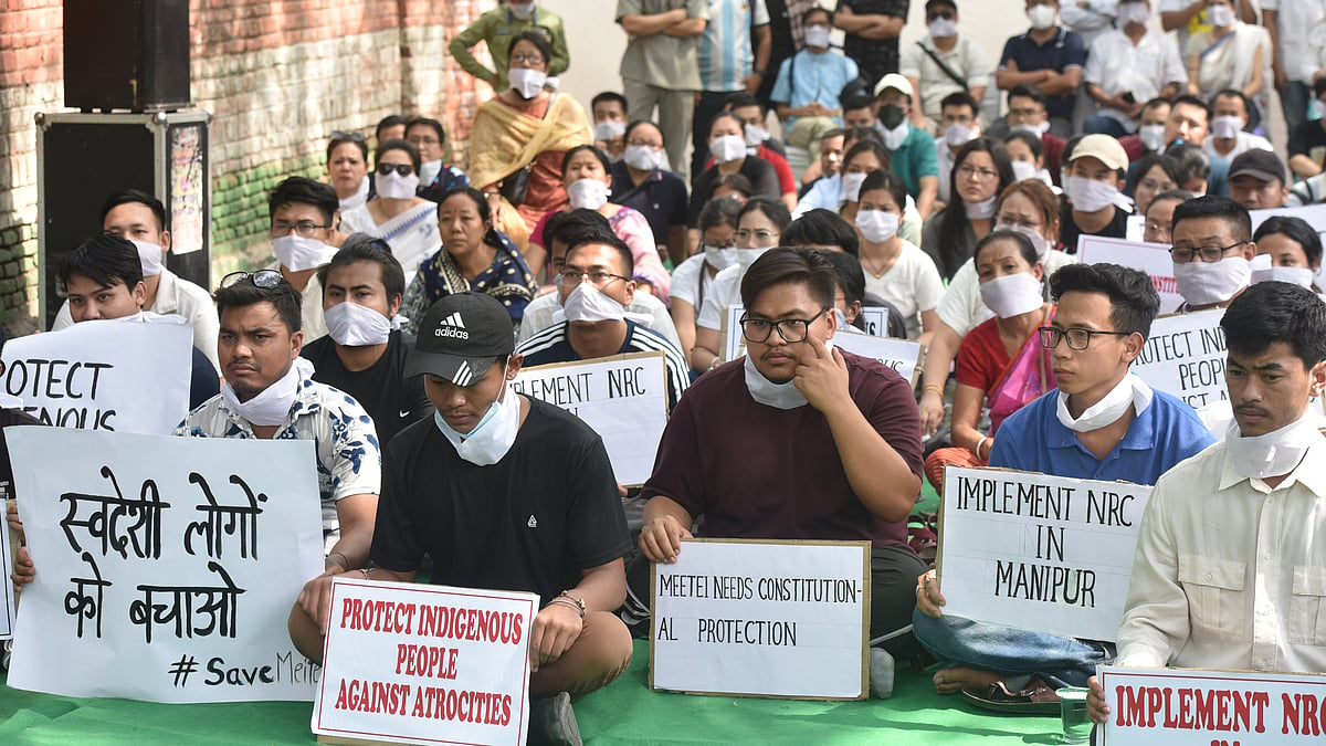 Meitei community people hold placards demanding the implementation of NRC in Manipur at Jantar Mantar (photo: Getty Images)