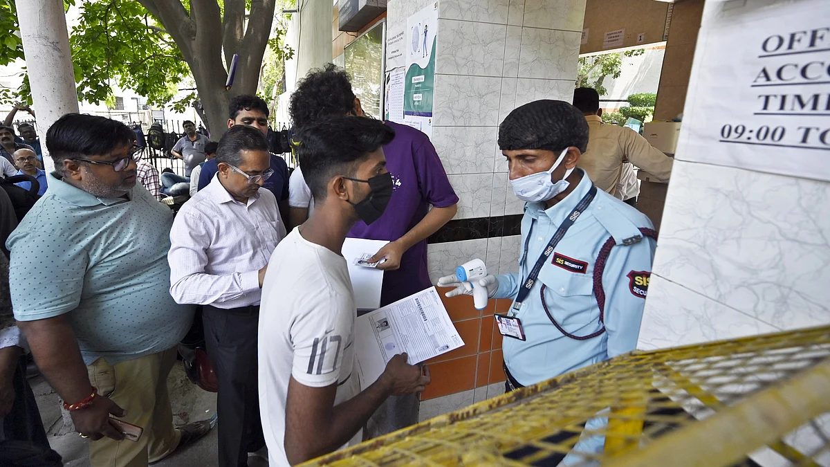 Aspirants undergo a security check before entering the exam centre as they arrive to appear for the NEET exam (photo: Getty Images)